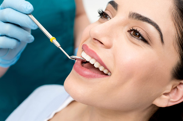beautiful-patient-receiving-dental-exam Young beautiful woman smiling after teeth whitening at Sue Walker Dentistry in Milwaukie, OR.